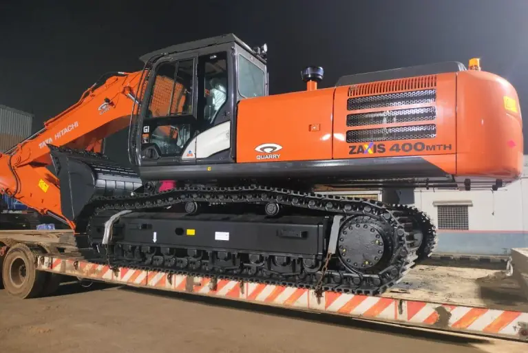 A Tata Hitachi Zaxis 400 MTH Quarry excavator loaded on a low-bed trailer for transport.